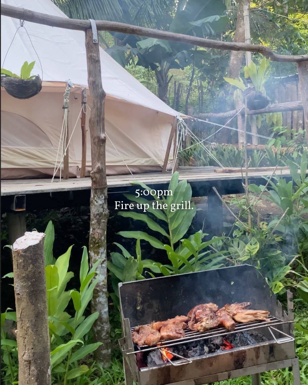BBQ grill firing up with bell tent in the background