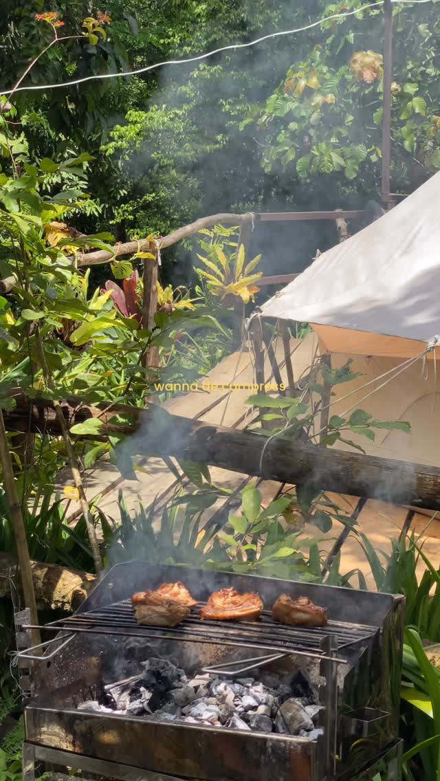 BBQ grill with chicken beside the bell tent deck